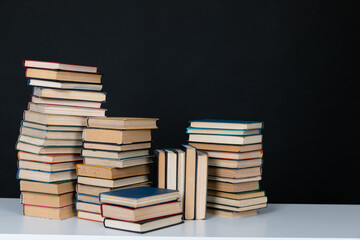 stack of books on a dark background in the library at the educational institution