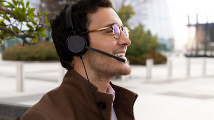 portrait of man smiling with glasses and headphones with microphone