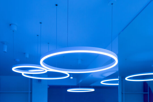 Ceiling with round modern LED lamps. Suspended fluorescent lights under the ceiling. Careful energy consumption, energy saving concept