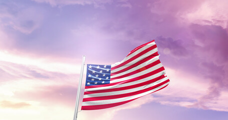 Waving Flag of United States in Blue Sky. The symbol of the state on wavy cotton fabric.