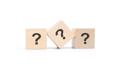 three wooden blocks with a question mark, top view on a white background