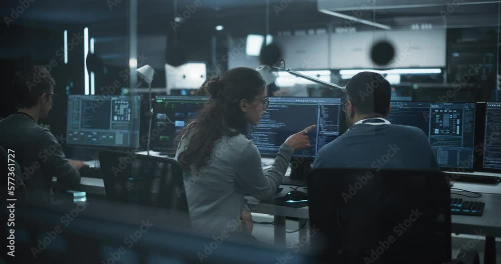 Fototapete Young Team of Specialists Working on Desktop Computers and Having a Conversation at a Workplace. Female and Male Software Developers Discussing a Solution for Their Artificial Intelligence Project