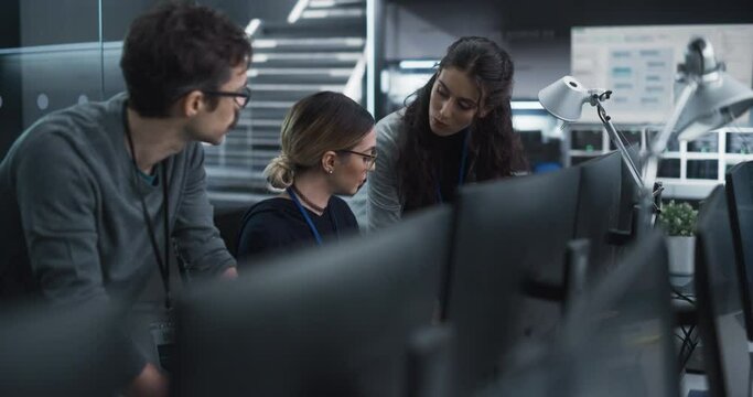Group of Empowered Multicultural Specialists Working in a Research Center, Using Computer to Collaborate on Advanced Software, Develop Artificial Intelligence Interface and Cloud-Based Blockchain