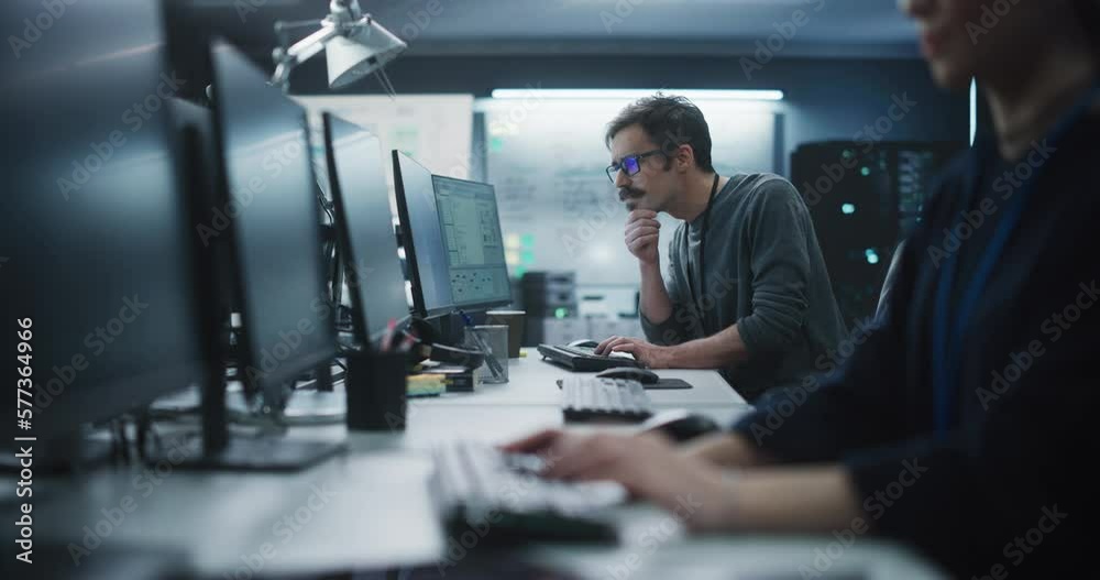 Poster Portrait of a Thoughtful Engineer Working on Desktop Computer in a Technological Office Environment. Research and Development Department Writing Software Code for an Innovative Internet Project