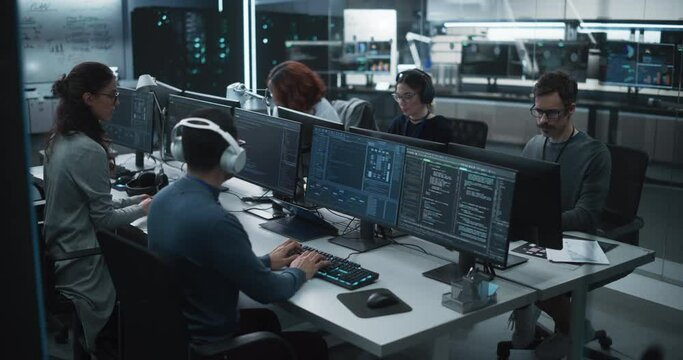 Team of Diverse Multiethnic Software Developers Working on Computers, Programming Advanced Code, Managing Artificial Intelligence Projects Online for Innovative Cyber Security Service. High Angle Shot