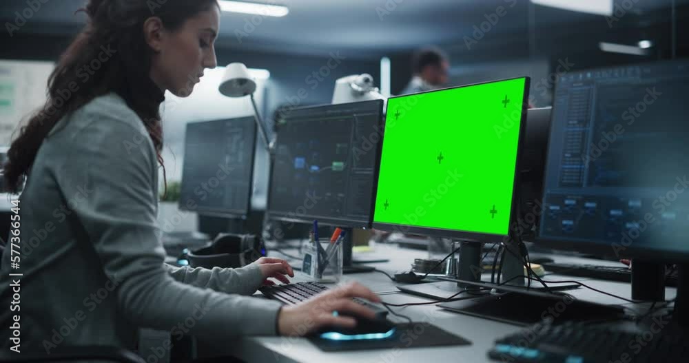 Leinwandbilder Female Software Developer Working on a Desktop Computer with Green Screen Mock Up Display. Specialist Typing on Keyboard, Coding and Implementing a New Technical Feature, Working in an Agency