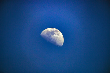 Beautiful white moon in the blue clear sky	
