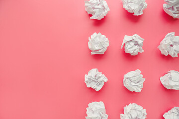 Crumpled paper balls on pink background. Brain storming and idea concept