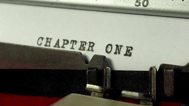 Typing chapter one of a novel or story on an old manual typewriter. Starting to write  a story at chapter one.