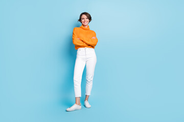 Fototapeta na wymiar Full length photo of lovely young lady confident folded arms employee freelancer wear trendy orange look isolated on blue color background