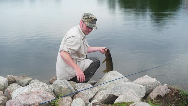 Fisherman showing off a pike he just caught