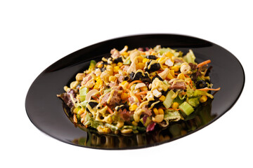 Delicious salad with lettuce, tuna fish and corn on a black plate