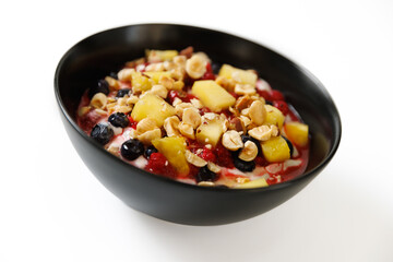 Healthy breakfast with natural yogurt, muesli, pineapple and fresh berries
