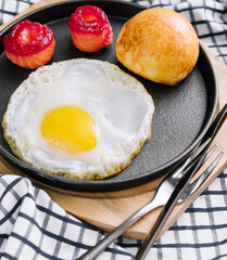 fried egg with salted red fish in a pan with coffee