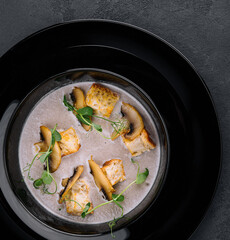 Creamy mushroom soup with champignons top view