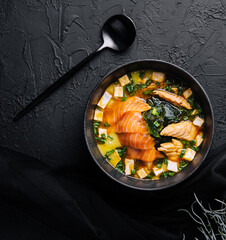 Appetizing ishikari miso soup with salmon in a black bowl