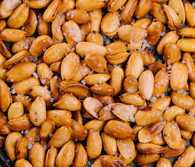 Organic roasted salty peanuts background