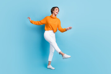 Fototapeta na wymiar Full body photo of attractive young woman dancing elegant party enjoy weekend wear trendy orange outfit isolated on blue color background