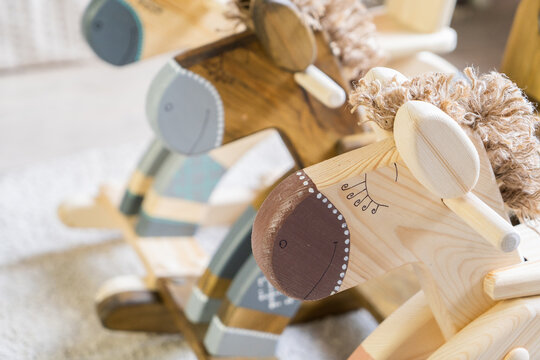 Handmade wooden toys horse swing for children in the nursery.