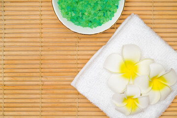 Spa treatment concept, flat lay composition with sea salt and lotus flower. View from above