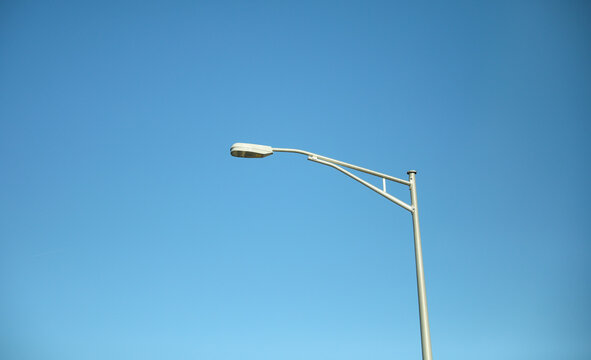 Street lamp post in the blue sky in the city and park 