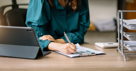 Asian woman hand Project manager working and update tasks and Gantt chart scheduling virtual diagram.with smart phone, tablet and laptop in office.