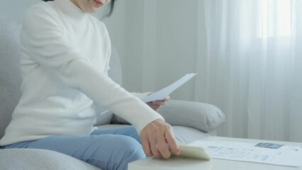 Modern woman use phone to scan barcode or QR codes to pay credit card bill after receiving document invoice online. payment, receive, paying electricity, digital payments without money, technology