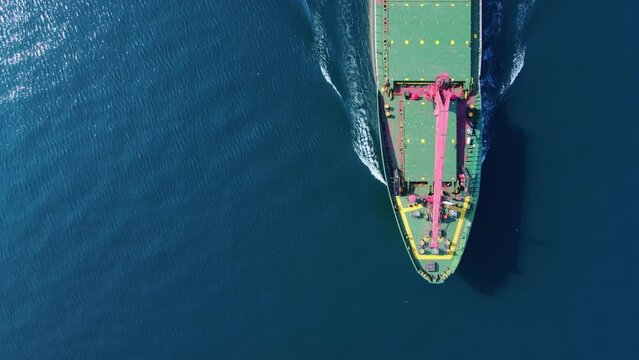 Forecastle of bulk cargo ship cruising in sea, Aerial top dow shot