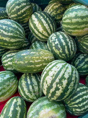 lots of ripe green watermelon vitamins healthy nutrition berries as background