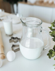 milk in a glass jug on the kitchen table