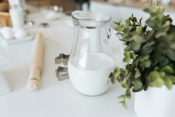 milk in a glass jug on the kitchen table