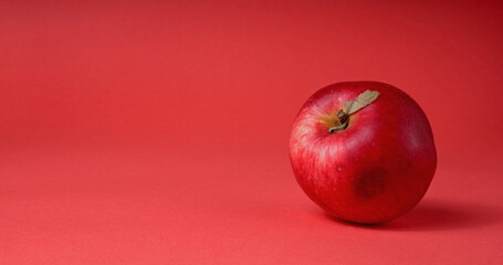 red apple on a red background