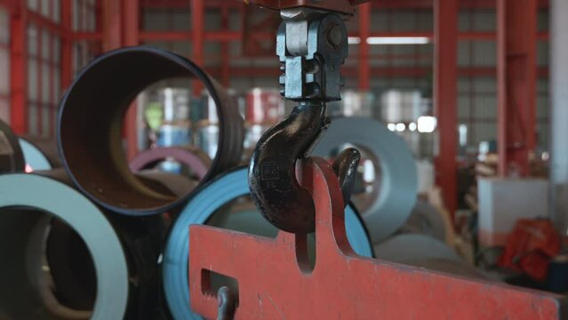 Closeup of swivel chain hook crane of electric hoist in factory workshop, pullersSwivel chain hook equipment for pullers, industry lifting machine