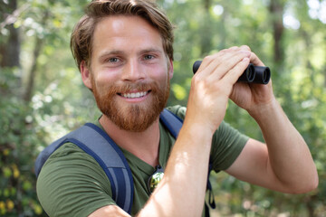 man with the field-glass watches birds
