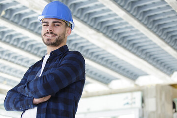 proud builder with folded arms indoors