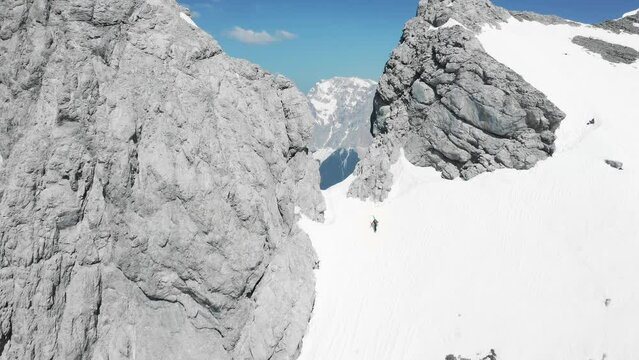 Ski tourer ascending snow-covered mountain gap, Tirol, Austria