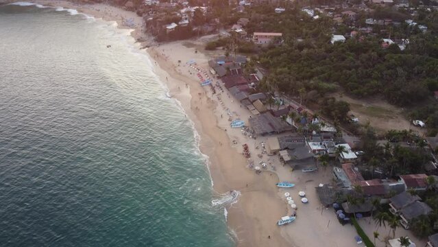 Aerial view of a breathtaking sunset over a tranquil beach.