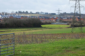 Urban sprawl in the form of a new housing estate encroaching on farmland near Exeter, Devon. Development of such rural sites has become a controversial issue in the UK