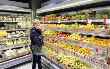 Woman buying fruits and vegetables at the market