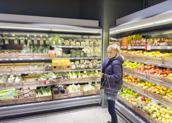 Woman buying fruits and vegetables at the market