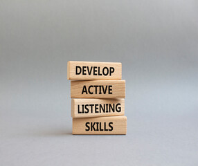 Listening skills symbol. Concept word Develop active listening skills on wooden blocks. Beautiful...