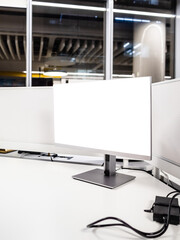 computer monitor with cutout screen on white desktop in office late at night