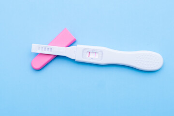 Positive pregnancy test on a blue background. Happy motherhood 