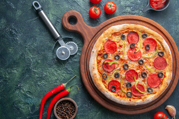 Fototapeta na wymiar Tasty pepperoni pizza and cooking ingredients tomatoes basil on black concrete background. Top view of hot pepperoni pizza. With copy space for text. Flat lay. Banner, Pizza Margherita on black stone 
