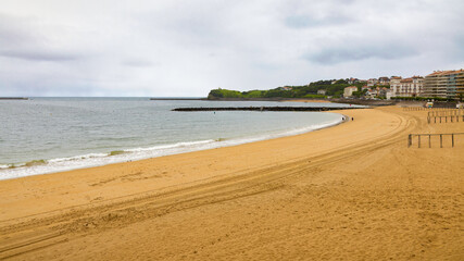 Panoramic view of the extensive beaches of Biarritz on a cloudy and rainy day. Biarritz, France