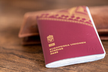 Close-up of a Swedish passport and a wallet for travel documents