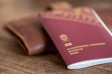 Close-up of a Swedish passport and a wallet for travel documents