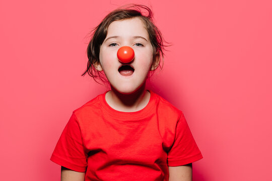 Little girl in red casual dress with red over nose