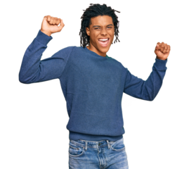 Young african american man wearing casual winter sweater dancing happy and cheerful, smiling moving casual and confident listening to music