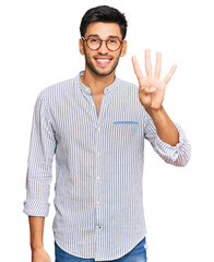 Young handsome man wearing casual clothes and glasses showing and pointing up with fingers number four while smiling confident and happy.